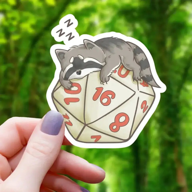 Raccoon Sleeping On D20 Sticker